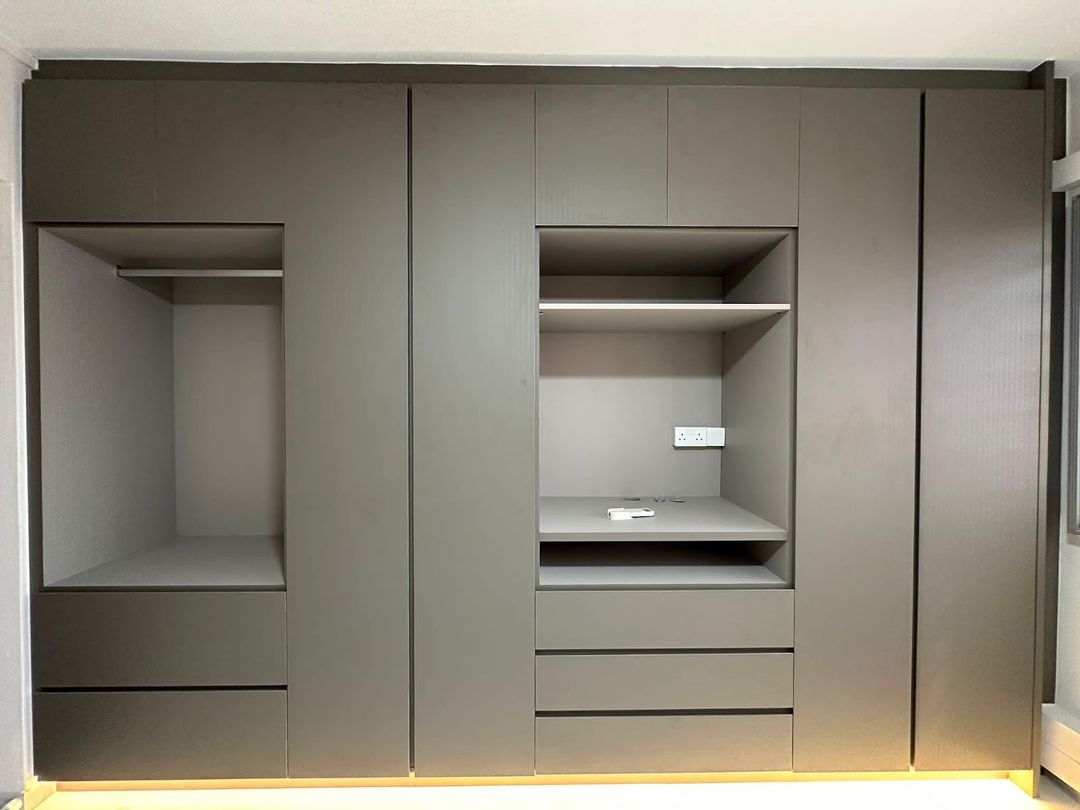 Wall-to-wall graphite wardrobe with the doors off, showing the hanging bays, open shelf, drawer stack and top boxes, built by Startec.