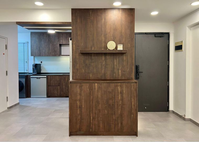 Entrance foyer with a freestanding dark wood-grain partition and floating shelf screening the kitchen beyond.